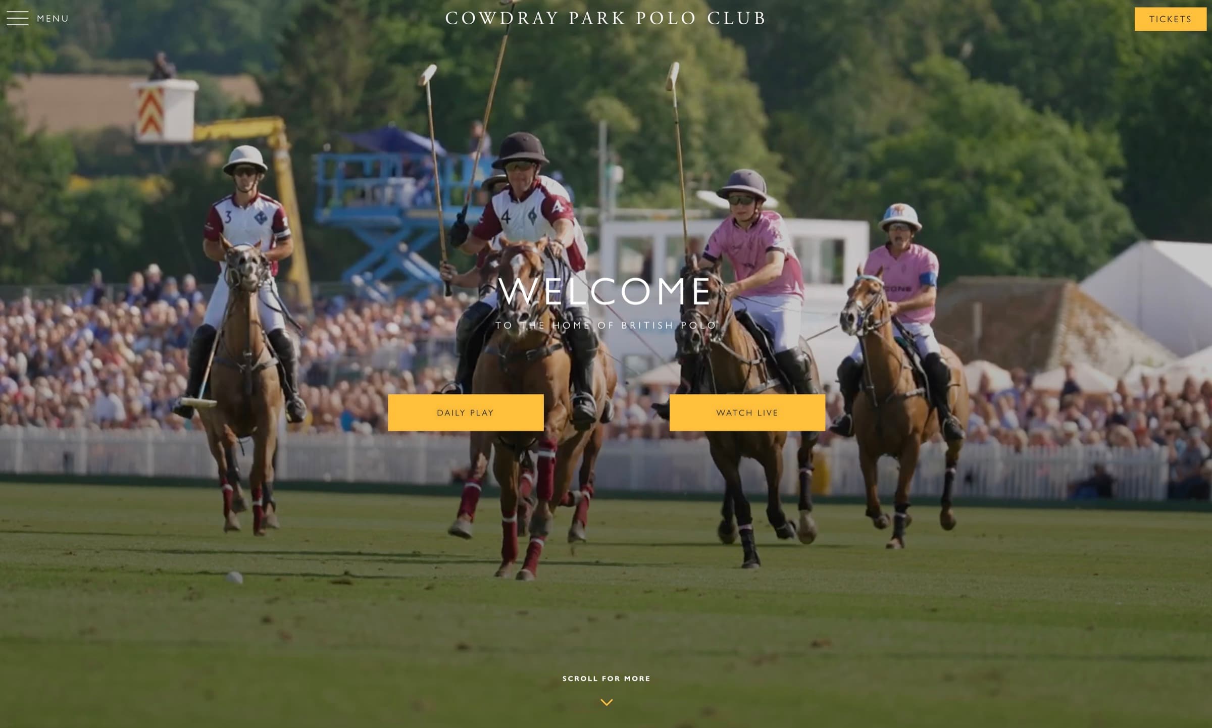 Four polo players mid-gallop on the lawn at Cowdray Park Polo Club, charging towards the camera with mallets raised. Spectators line the boundary fence behind them.